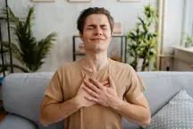 A man clutching his chest. (Heart)