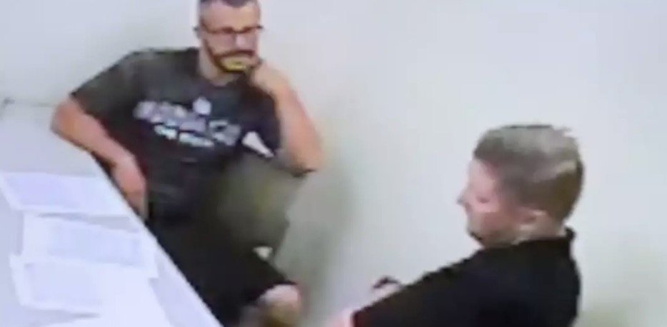 Watts repeatedly touched his neck during the interrogation. Credit: Netflix